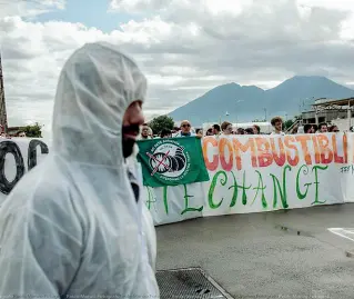  ??  ?? Lo striscione Uno degli attivisti davanti al cancello della Q8 di Napoli