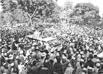  ??  ?? Pakistani supporters gather around an ambulance carrying the body of a key cleric Maulana during his funeral ceremony in his hometown of Akora Khattak, located around 115 kilometres northwest of Islamabad. — AFP photo