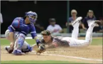  ?? TONY DEJAK — THE ASSOCIATED PRESS ?? The Indians’ Giovanny Urshela slides safely into home plate as Blue Jays catcher Miguel Montero tries to get hold of the ball during the fourth inning July 23 at Progressiv­e Field. Urshela scored on an RBI single by Francisco Lindor.