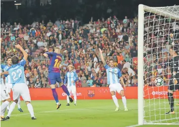  ??  ?? Barcelona’s Gerard Deulofeu scores their first goal. — Reuters photo