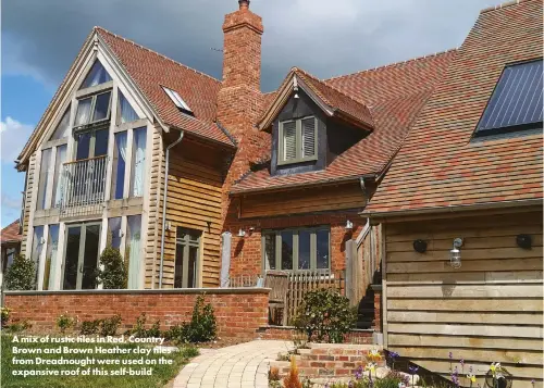  ?? ?? A mix of rustic tiles in Red, Country Brown and Brown Heather clay tiles from Dreadnough­t were used on the expansive roof of this self-build