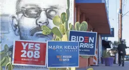  ?? NICK OZA/THE REPUBLIC ?? Signs supporting Democratic Presidenti­al and VP candidate Joe Biden and
Kamala Harris, as well as Mark Kelly and Propositio­n 208, are seen at Barrio Cafe, owned by Silvana Salcido Esparza, in Phoenix Oct 8. Esparza isn’t afraid to voice her politics. Now the Phoenix chef is taking her story to Joe Biden’s presidenti­al campaign.