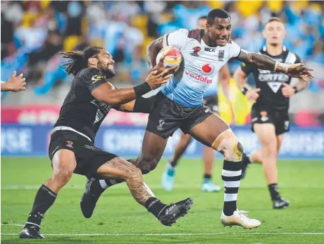  ?? Picture: MARTY MELVILLE ?? Fijian winger Suliasi Vunivalu steams past New Zealand prop Adam Blair in the quarter-finals.