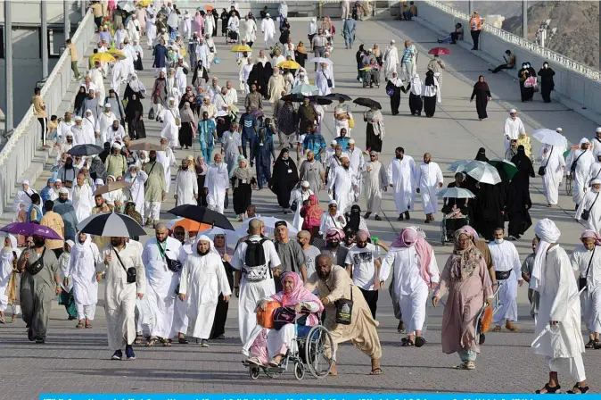  ??  ?? MINA: Muslim worshipper­s arrive in Mina to throw pebbles as part of the symbolic Al-A’qabah (stoning of the devil ritual) at the Jamarat Bridge during the hajj pilgrimage, near Saudi Arabia’s holy city of Makkah.