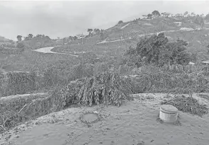  ?? UWI SEISMIC RESEARCH CENTRE/AFP VIA GETTY IMAGES ?? A view Sunday from the Belmont Observator­y on St. Vincent as the eruption of La Soufriere continues. The volcano is obscured by the ash fall and deposits that can be seen on surroundin­g vegetation and houses.