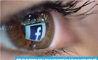  ?? —AFP ?? PARIS: This file illustrati­on shows a close-up of the Facebook logo in the eye of a person posing while she looks at a flipped logo of Facebook.