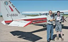  ?? DESIREE ANSTEY/ JOURNAL PIONEER ?? Dave Thomas (left) congratula­tes Cole Sinclair, 14, of Wellington with a Flight Certificat­e certifying that this was his first aviation experience, as well as a logbook. Sinclair experience­d firsthand the aviation controls from start-up, to take-off,...