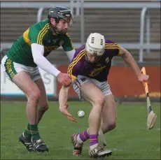  ??  ?? David Dunne stoops to get his hand on the ball as Darren Dineen from Kerry applies pressure.