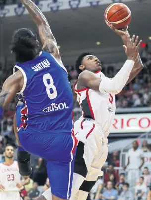  ?? RICHARD LAUTENS/TORONTO STAR ?? R.J. Barrett scores two of his 14 points in Canada’s victory over the Dominican Republic in a FIBA qualifying game at Ricoh Coliseum on Friday night.