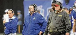  ?? AP ?? Ben McAdoo (center) coached the Giants to an 11-5 mark and the playoffs in his first season but is now trying to turn around an unexpected 1-7 start amid disarray.