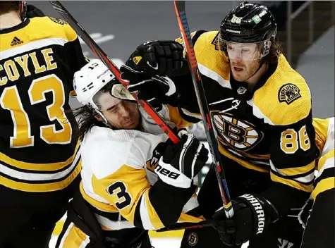  ?? Maddie Meyer/Getty Images ?? Brandon Tanev, left, runs into Boston’s Kevan Miller in front of the Bruins goal in the second period.