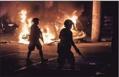  ?? aP-ricardo B. Brazziell ?? Police stand guard as Austin Fire Department put out a car fire under Interstate 35 freeway in Austin Texas on Saturday.