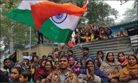  ?? REUTERS ?? People, who have migrated from Pakistan’s Sindh Province, cheer as they celebrate after the Parliament passed Citizenshi­p Amendment Bill (CAB), in Ahmedabad, on Thursday.