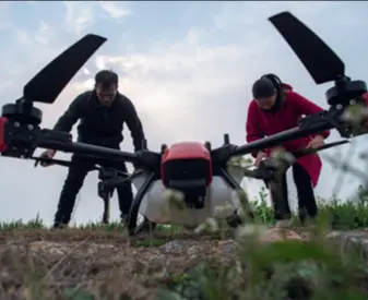  ?? ?? Two farmers adjust a crop protection unmanned aerial vehicle before flying it in a village in Tianmen, Hubei Province, on March 1, 2023