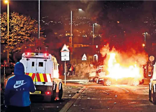  ??  ?? Lyra Mckee, top right, was shot dead in Creggan, above; a still from CCTV of the suspected gunman, above right; Sinn Féin’s Mary Lou Mcdonald and the DUP’S Arlene Foster join a vigil, inset below