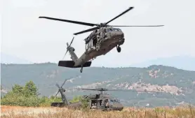  ?? GUARD VIA CAPT. ALEXANDRA CURTIS
PROVIDED BY RI NATIONAL ?? Paratroope­rs from Rhode Island’s Charlie Company, 1/143rd Airborne Infantry, prepare to jump from a lift company (A-1/126th) helicopter.