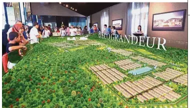  ??  ?? Major contributo­r: The public viewing a model of the Eco Grandeur project. EcoWorld Malaysia attributes its improved earnings before interest and tax to three of its Malaysian joint ventures – Eco Grandeur, Eco Ardence and Bukit Bintang City Centre.