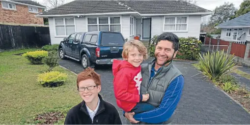  ?? Photo: FAIRFAX NZ ?? Anton Verryt with his sons, Connor, left, and Jude, outside their new home in Green Bay, Auckland.