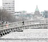  ??  ?? Quiet: A sole pedestrian crosses the Ha’penny Bridge in lockeddown Dublin city centre yesterday.