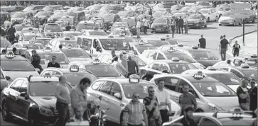  ??  ?? TAXICABS block roads in Paris. French taxi drivers cut off access to major airports and train stations and attacked vehicles suspected of working for the car service Uber, which they accuse of stealing their livelihood­s.