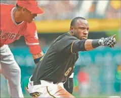  ?? Justin Berl Getty Images ?? STARLING MARTE of the Pirates reacts after hitting a triple during the third inning of a game against the Angels on Saturday.