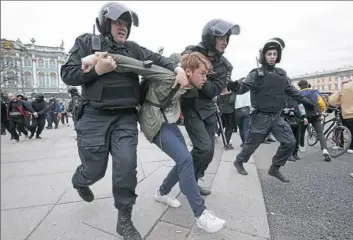  ?? Dmitri Lovetsky/Associated Press ?? Russian police detain a protester at a demonstrat­ion Saturday against President Vladimir Putin in St. Petersburg. Police arrested hundreds, including protest organizer Alexei Navalny, the anti-corruption campaigner who is Mr. Putin’s most prominent foe.