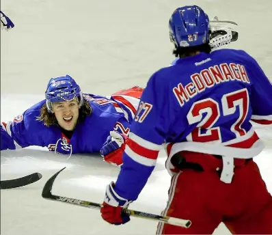  ?? Julie Jacobson/Associated Press ?? Rangers left wing Carl Hagelin celebrates after scoring the winning goal in overtime of Game 5 against the Penguins Friday in New York. The Rangers won, 2-1, to take the series and advance to the second round.