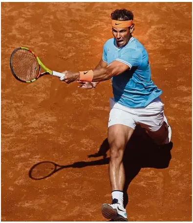  ?? — AP ?? Back to you: Spain’s Rafael Nadal returning a shot to Argentina’s Leonardo Mayer during the second round of the Barcelona Open on Wednesday.