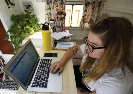  ?? NAM Y. HUH — THE ASSOCIATED PRESS ?? Kelly Mack works on her laptop to teach remotely from her early 1940s vintage camper/trailer in her backyard at home in Evanston, Ill., on Sept. 2, 2020.