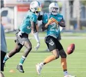  ?? LYNNE SLADKY/AP ?? Miami Dolphins defensive back Tony Lippett, left, and defensive back Minkah Fitzpatric­k run a drill on Thursday.