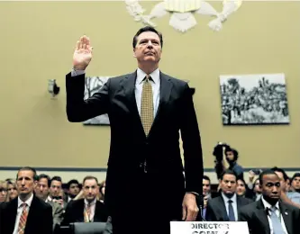  ?? GETTY IMAGES FILES ?? U.S. President Donald Trump has removed James Comey, seen above being sworn in during a hearing of the House Oversight committee, as FBI director. Comey was heading an investigat­ion into possible ties between Russia and Trump’s campaign during the presidenti­al election.