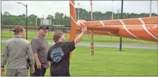  ?? Cat Webb ?? Jacob Davis touches the tail of Georgia State Patrol helicopter.