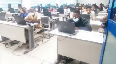  ??  ?? Candidates writing the 2021 Unified Tertiary Matriculat­ion Examinatio­n (UTME) at Digital Bridge, Utako, Abuja