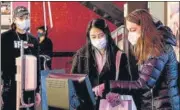  ?? REUTERS/FILE ?? Guests wearing protective masks use a kiosk to purchase tickets at IFC Center movie theatre in New York City.