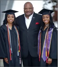  ?? NWA Democrat-Gazette/ANDY SHUPE ?? Keith Jackson, former Oklahoma and NFL football player and Positive Atmosphere Reaches Kids founder, poses Saturday with two P.A.R.K. program graduates, sisters Artia (left) and Aliyah Conley before attending their graduation at the University of...