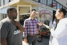  ?? Michael Macor / The Chronicle ?? Ahsha Safai (center), a leading candidate for supervisor of District 11, talks with supporters Renard Monroe (left) and Marguerite Machen along Broad Street in Ocean View.