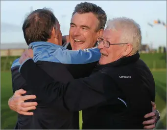  ??  ?? Simonstown manager Colm O’Rourke, centre, celebrates with Jim McCabe, teammentor, and Jim Lane, Simonstown GAA chairman, right.