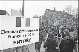  ?? THE CANADIAN PRESS] [GRAHAM HUGHES/ ?? French citizens living in Canada wait in line to vote in the 2017 French presidenti­al election in Montreal. While French living outside the country voted on Saturday, those in France go to the polls today.