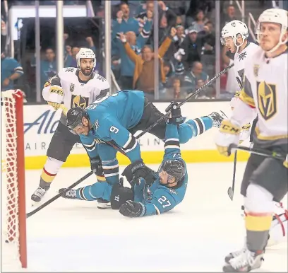  ?? ARIC CRABB — STAFF PHOTOGRAPH­ER ?? Joonas Donskoi slides on the ice after his first-period goal as Sharks teammate Evander Kane tumbles over him.