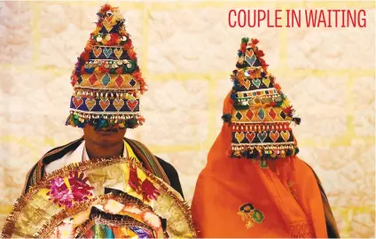  ?? Picture: Reuters ?? A bride and groom wearing traditiona­l handmade garlands wait for their wedding to start during a mass marriage ceremony in Karachi, Pakistan.