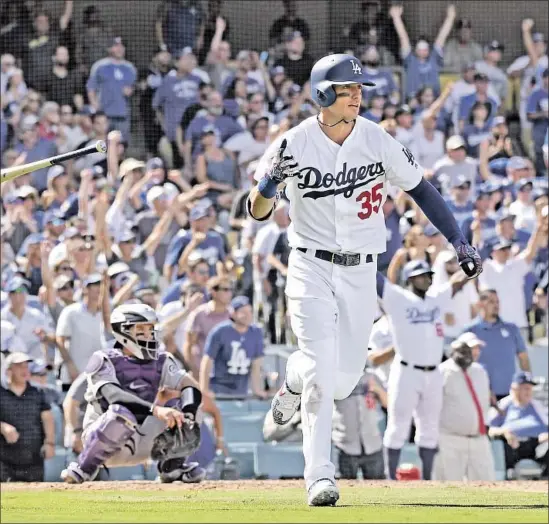  ?? Wally Skalij Los Angeles Times ?? CODY BELLINGER hits a two-run home run in the fourth inning to end a scoreless tie and start the Dodgers on the way to a 5-2 victory over the Colorado Rockies.