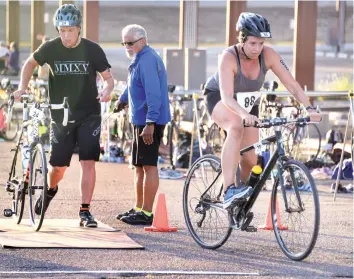  ?? NEW MEXICAN FILE PHOTO ?? Bridget Love, 35, and Austin Wade, 20, prepare to begin the 12-mile bike ride during the 2016 City of Santa Fe Sprint Triathlon. The coordinato­r for this year’s triathlon, Liz Roybal, is hoping to improve the participat­ion numbers, which fell...