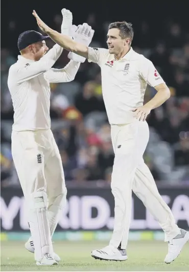  ??  ?? 0 Chris Woakes, right, celebrates with Jonny Bairstow after dismissing Steve Smith.