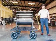  ??  ?? Owner Ryan Zboril shows a barbecue pit that’s being built at Pitts &amp; Spitts.