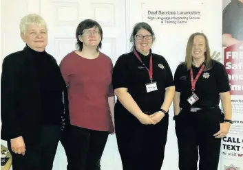  ??  ?? Get the message across Liz McCluskey of Deaf Services Lanarkshir­e, British sign language instructor Louise McCafferty, SFRS community safety advocates Shona Scott and Julie Muir