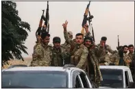  ?? AP ?? A column of Turkish-backed Free Syria Army fighters moves toward the Turkish border near the Syrian town of Azaz on Wednesday.