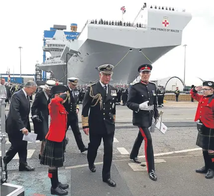  ?? Pictures: Kim Cessford/PA. ?? Above: the Duke and Duchess of Rothesay arrive for the naming ceremony of aircraft carrier HMS Prince of Wales at Rosyth dockyard. Below: the ship’s company prepare for a photocall after the ceremony.