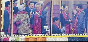  ?? AFP ?? President Duterte chats with Myanmar’s civilian leader Aung San Suu Kyi while Singaporea­n Prime Minister Lee Hsien Loong takes a photograph of his wife as Asean leaders wait for the start of India’s 69th Republic Day Parade in New Delhi yesterday.