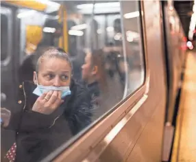  ?? JOHN MINCHILLO/AP ?? A passenger looks out onto the platform Wednesday while riding a northbound train in 36th Street subway station where a shooting attack occurred the previous day in New York.