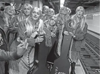  ?? — AFP photo ?? Woman from Best Friends to Save Them All, dressed up as Phoebe Buffay from the sitcom ‘Friends’, wait for a subway at Grand Central Terminal in New York.